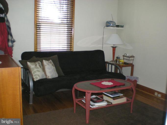 2115 Stonewall Road Catonsville, MD 21228 - Photo 10 of 19 a living room with furniture a table and a window