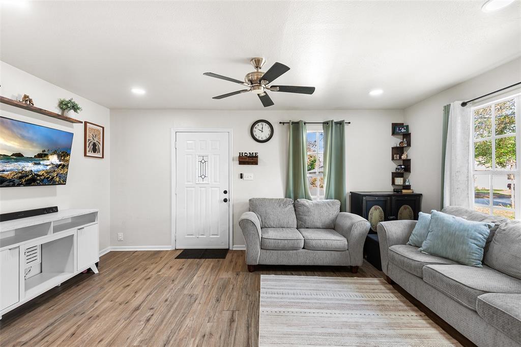 515 Walnut Street Auburndale, FL 33823 - Photo 11 of 45 a living room with furniture a large window and a fireplace