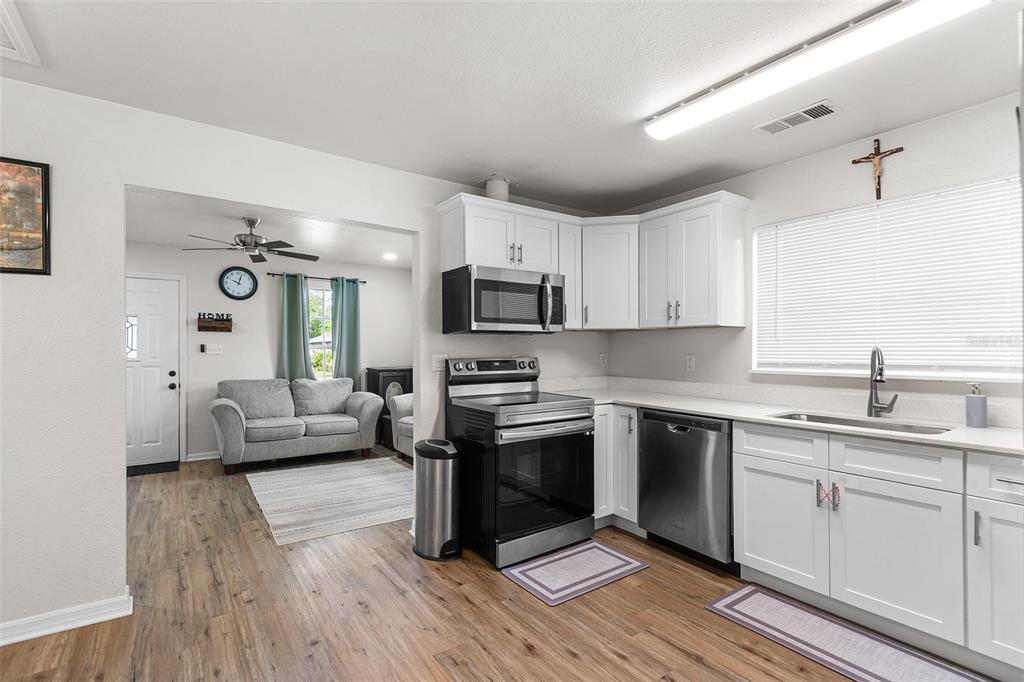 515 Walnut Street Auburndale, FL 33823 - Photo 12 of 45 a kitchen with a sink cabinets and wooden floor