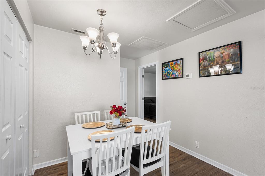 515 Walnut Street Auburndale, FL 33823 - Photo 13 of 43 a view of a dining room with furniture wooden floor and a chandelier