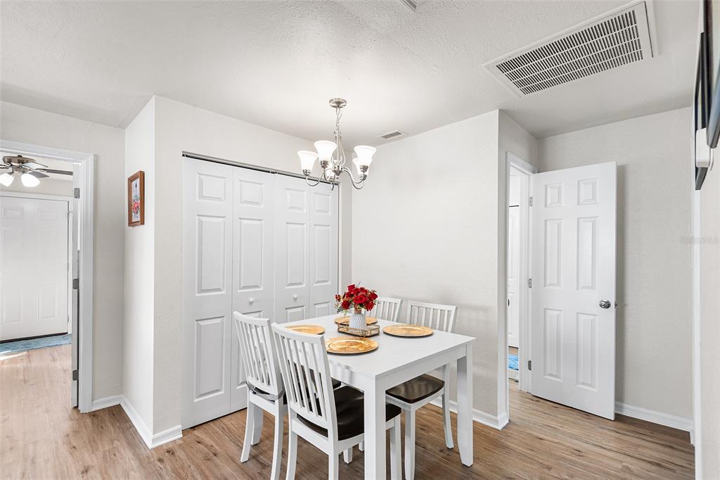 515 Walnut Street Auburndale, FL 33823 - Photo 16 of 45 a view of a dining room with furniture wooden floor and a chandelier