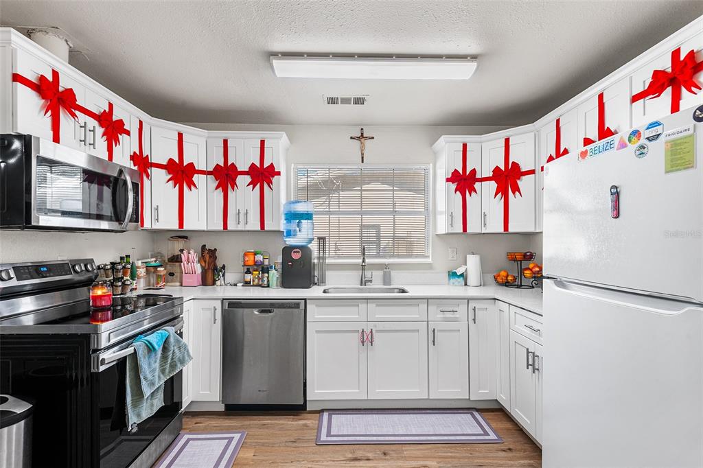 515 Walnut Street Auburndale, FL 33823 - Photo 17 of 43 a kitchen with a white cabinets and white appliances