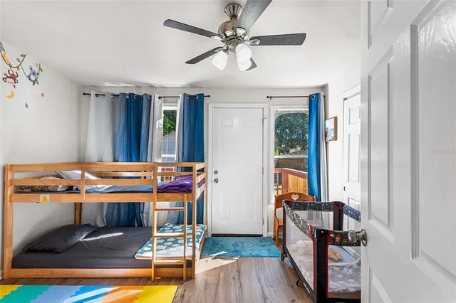 a bedroom with a bed and wooden floor