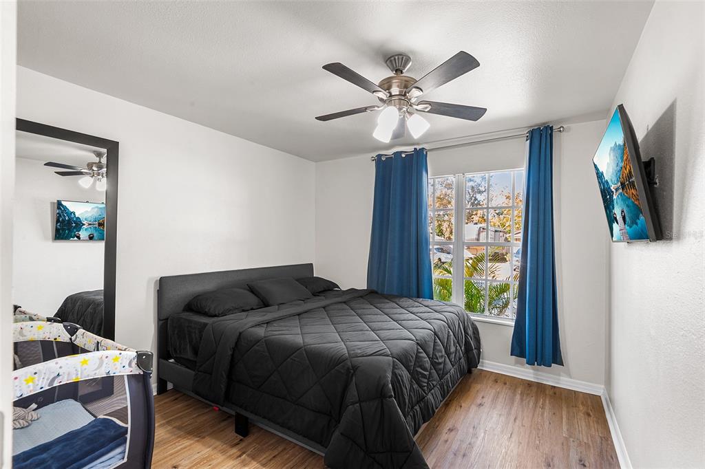 515 Walnut Street Auburndale, FL 33823 - Photo 21 of 43 a bedroom with a bed and wooden floor