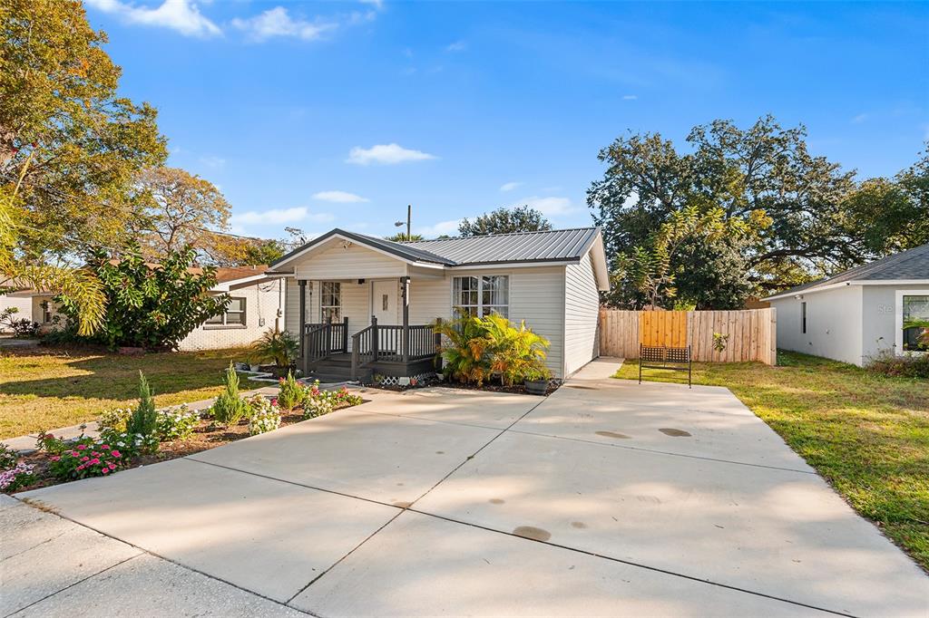515 Walnut Street Auburndale, FL 33823 - Photo 3 of 43 a front view of a house with a garden and lake view