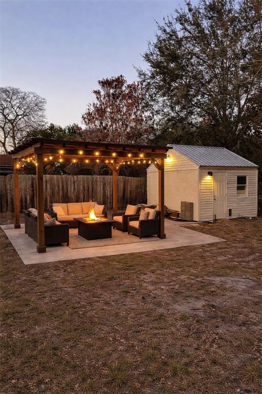 515 Walnut Street Auburndale, FL 33823 - Photo 7 of 45 a view of a backyard with table and chairs and a fire pit