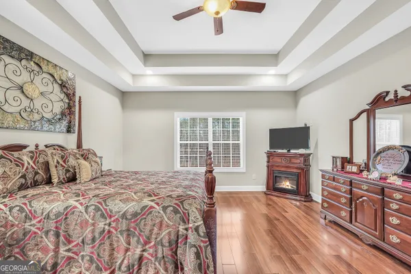 a kitchen with stainless steel appliances granite countertop a stove top oven a sink dishwasher a dining table and chairs with wooden floor