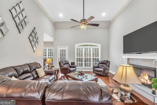 a living room with furniture fireplace and a flat screen tv