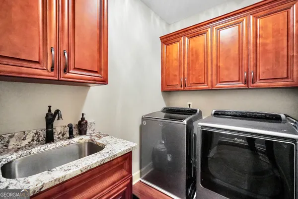 a kitchen with stainless steel appliances granite countertop a sink a stove and cabinets