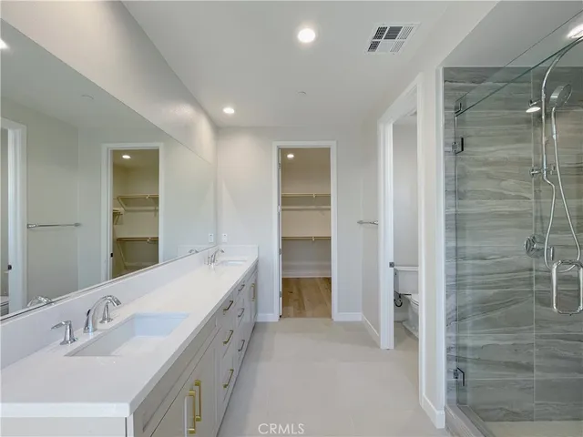 a spacious bathroom with a double vanity sink shower and a mirror