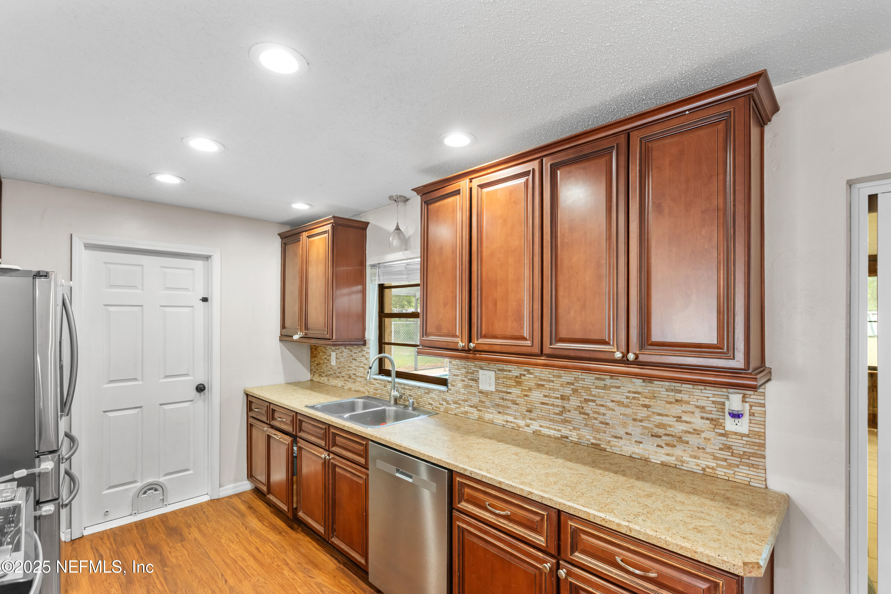 220 Southwest Grove Street Keystone Heights, FL 32656 - Photo 11 of 41 a bathroom with a granite countertop sink and a bathtub
