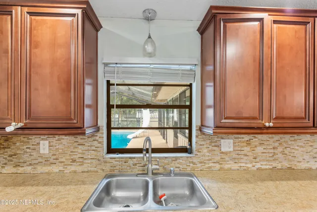 a bathroom with a sink a mirror and a window