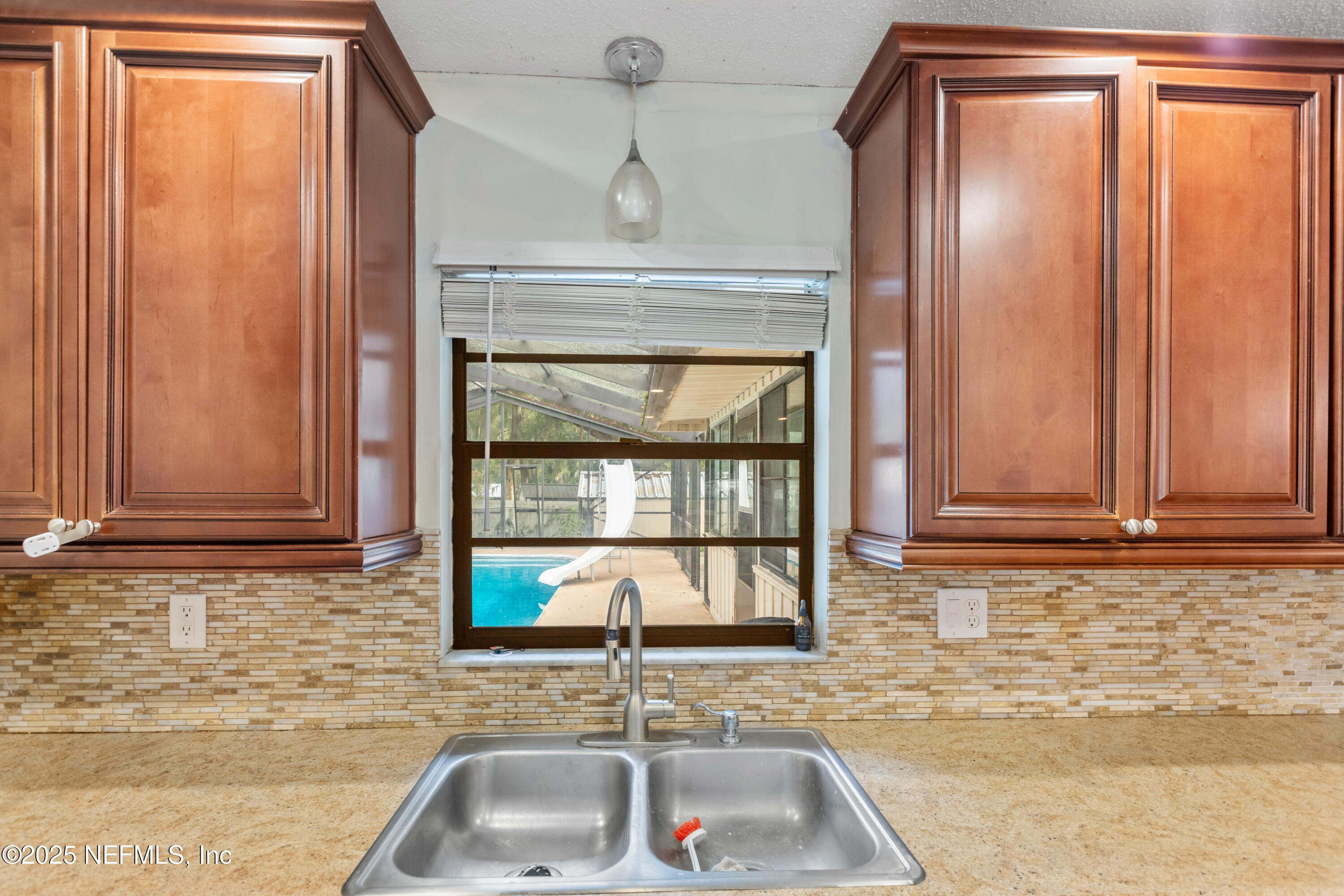 220 Southwest Grove Street Keystone Heights, FL 32656 - Photo 12 of 41 a bathroom with a sink a mirror and a window