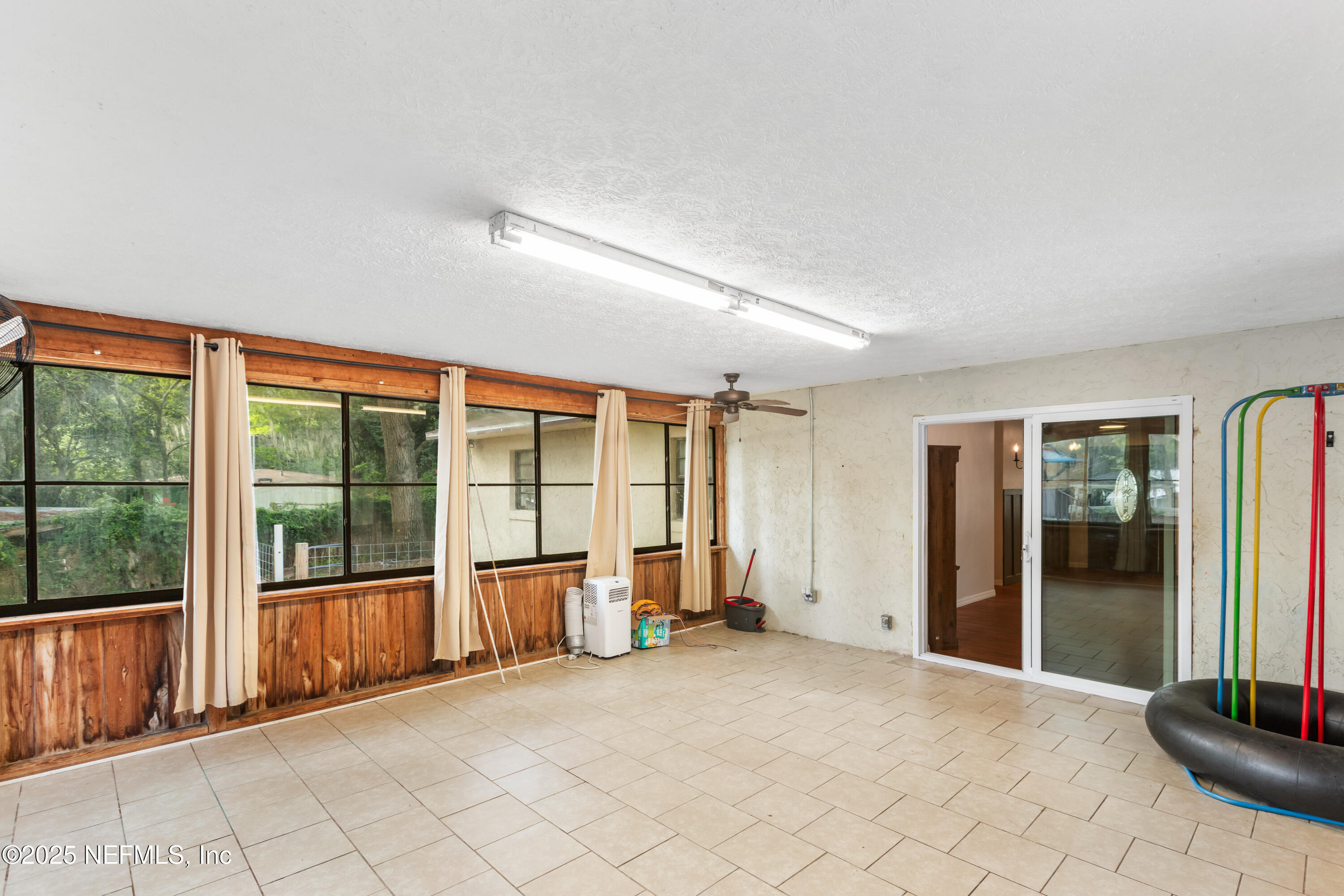 220 Southwest Grove Street Keystone Heights, FL 32656 - Photo 15 of 41 an empty room with windows and chandelier