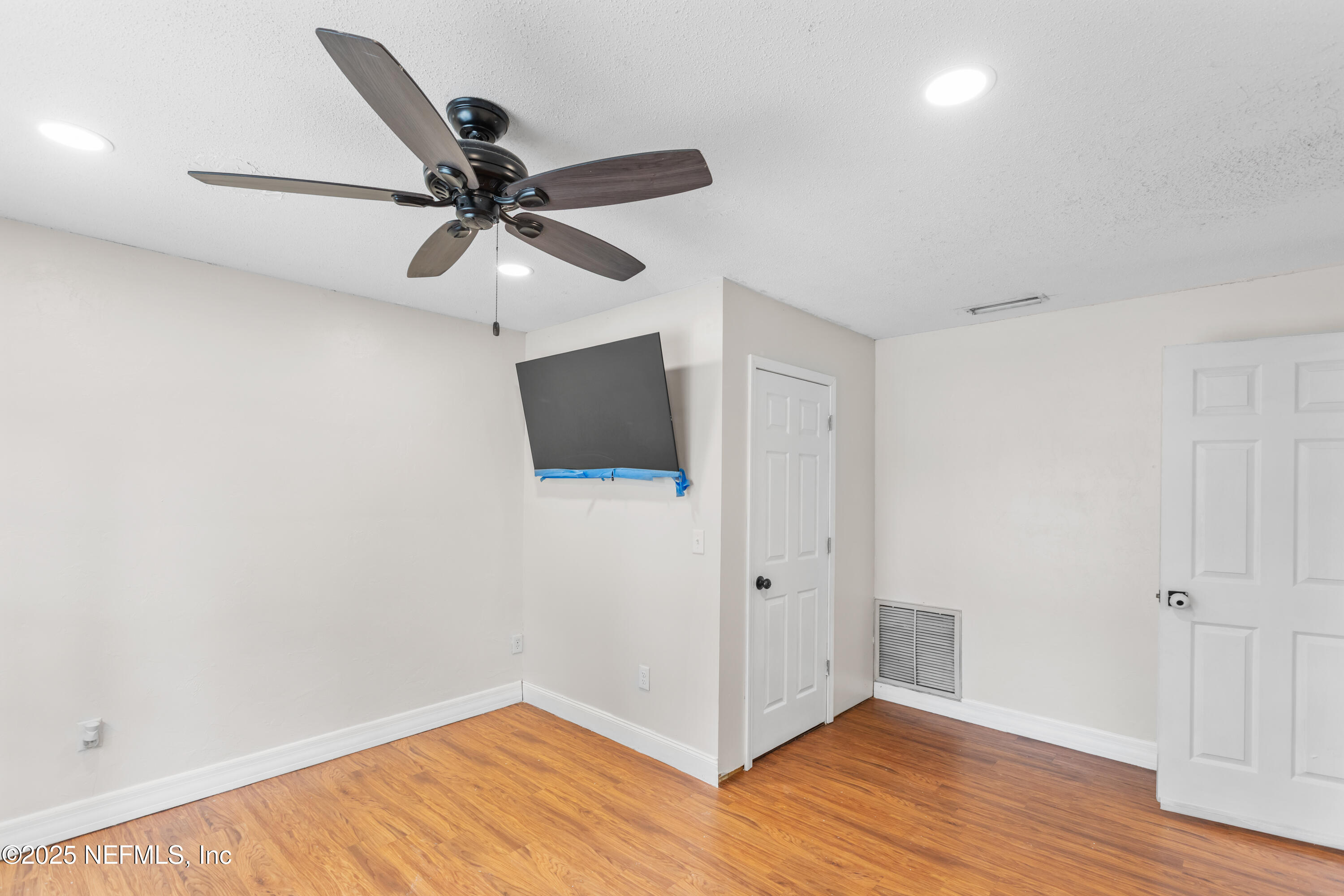 220 Southwest Grove Street Keystone Heights, FL 32656 - Photo 17 of 41 a view of a hallway with wooden floor and a ceiling fan