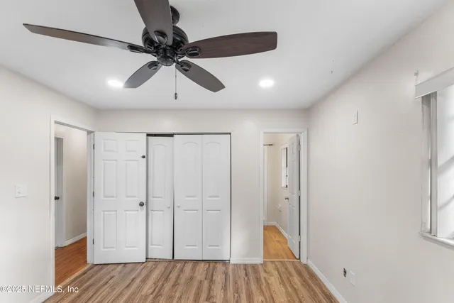 a view of empty room with wooden floor