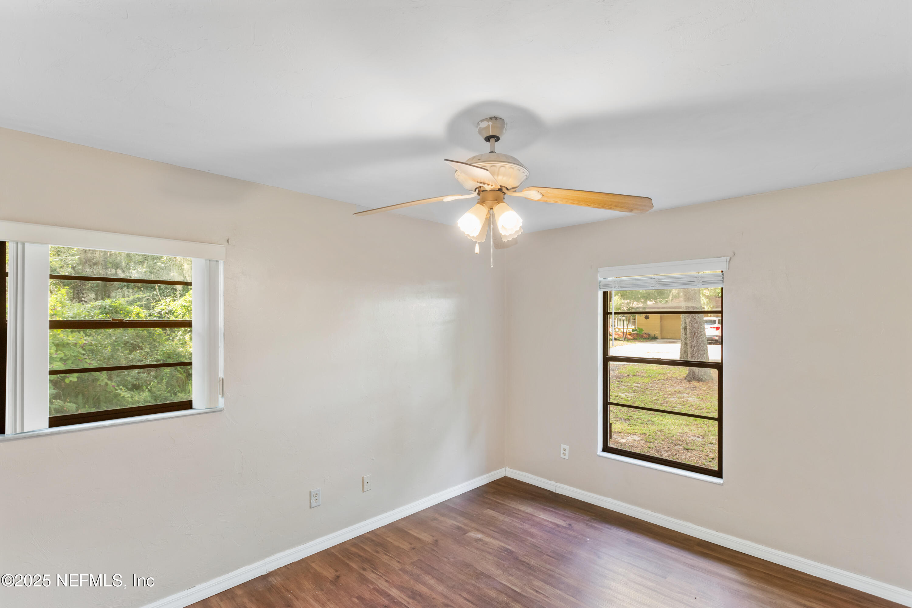 220 Southwest Grove Street Keystone Heights, FL 32656 - Photo 26 of 41 a view of an empty room with wooden floor and a window