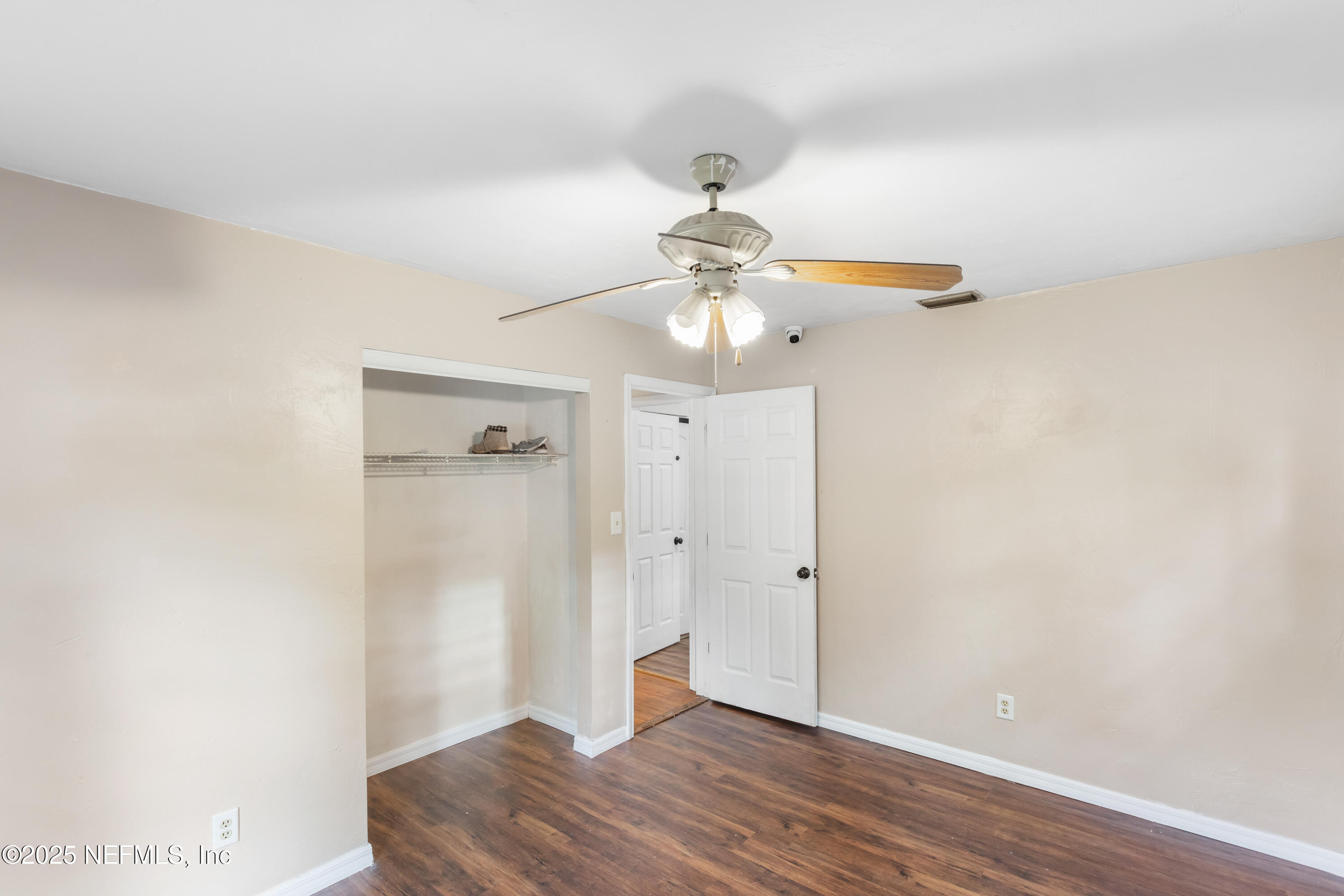 220 Southwest Grove Street Keystone Heights, FL 32656 - Photo 27 of 41 an empty room with wooden floor fan and windows