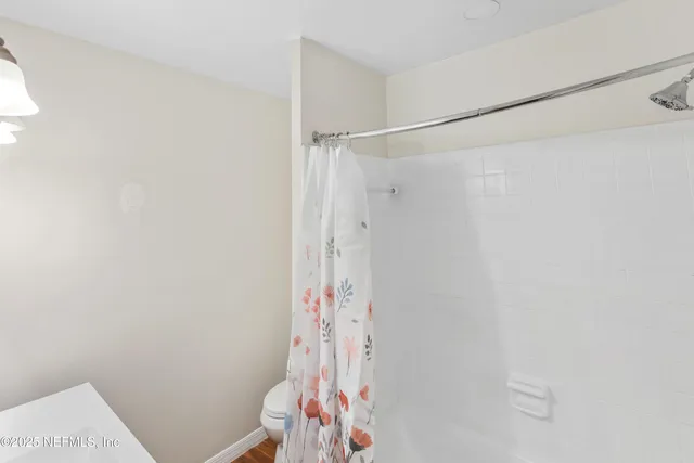 a bathroom with a shower and a shower curtain