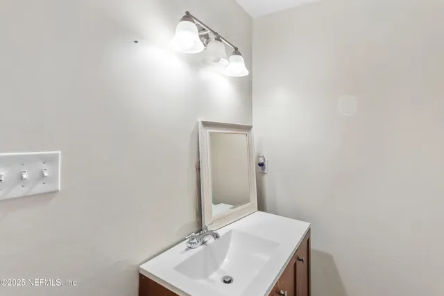 a bathroom with a sink and mirror