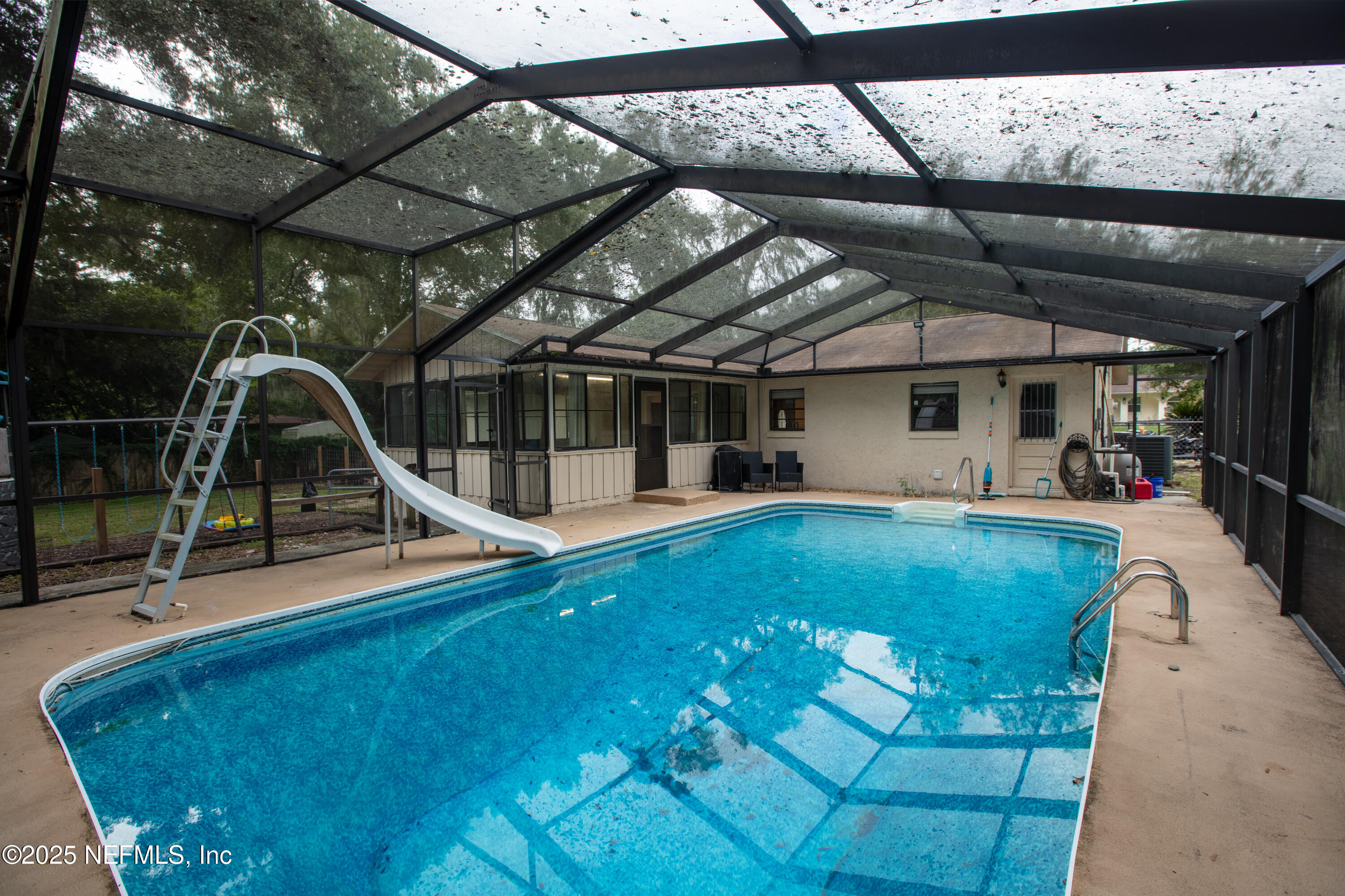 220 Southwest Grove Street Keystone Heights, FL 32656 - Photo 34 of 41 a view of a swimming pool with a patio and a garden