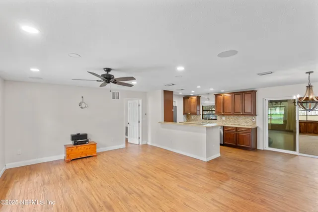 a bedroom with a bed and a view of kitchen