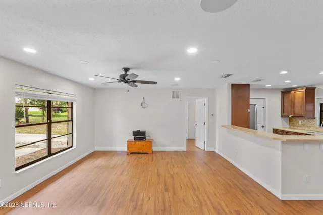a view of a kitchen with wooden floor and a kitchen