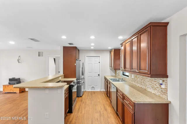 a kitchen with a sink stove and cabinets