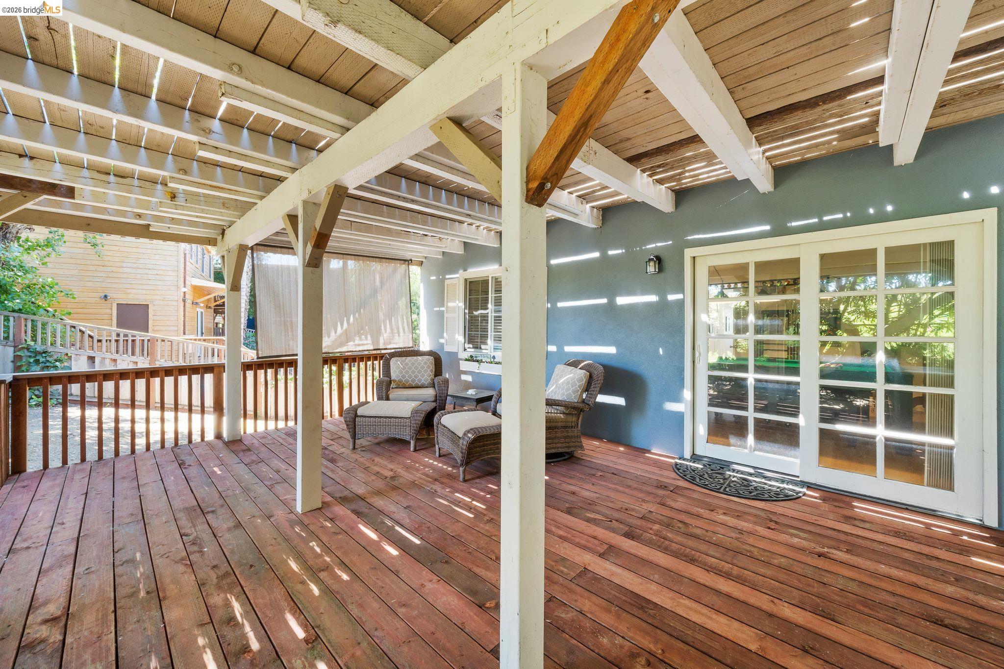 1704 Taylor Road Bethel Island, CA 94511 - Photo 63 of 73 Spacious wood-finish deck with a pergola-style cover, featuring white support beams and a partial privacy screen