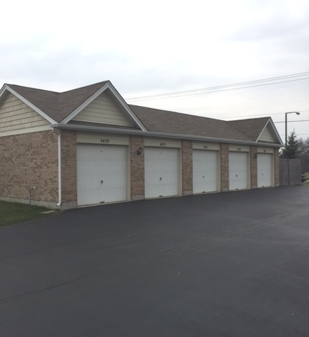 4457 Timber Ridge Court, Unit 4457 Joliet, IL 60431 - Photo 3 of 3 a view of garage and yard