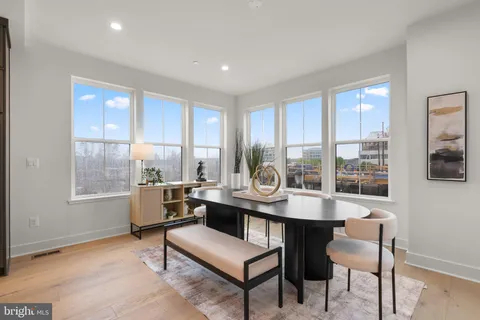 a kitchen with a table chairs microwave and cabinets