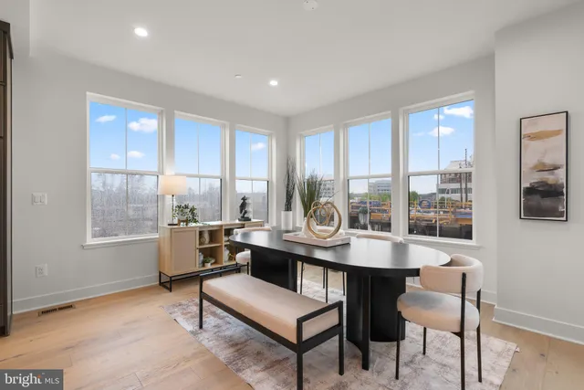 a kitchen with a table chairs microwave and cabinets