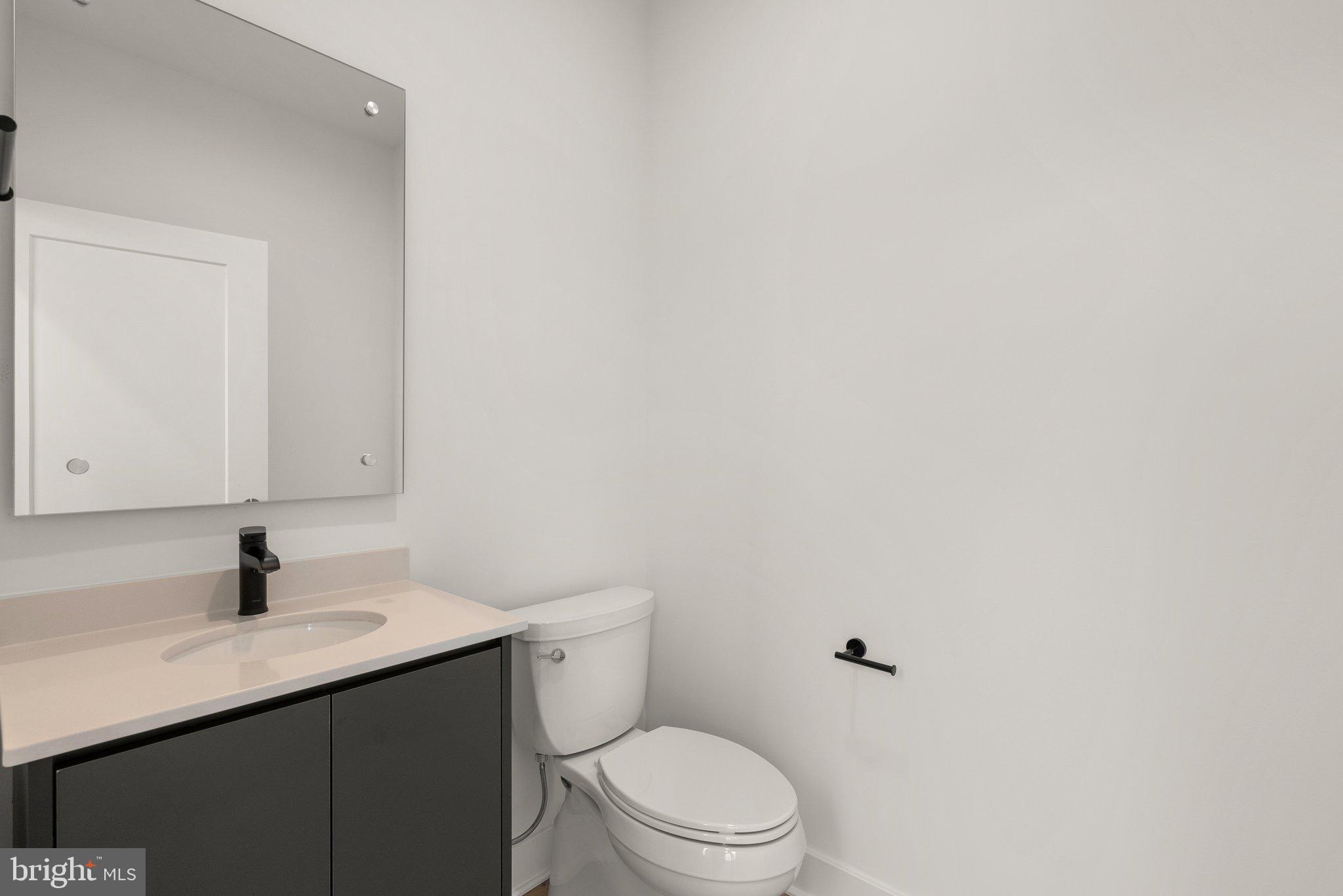 1121 Polaris Road Potomac, MD 20854 - Photo 13 of 51 a bathroom with a toilet sink and mirror