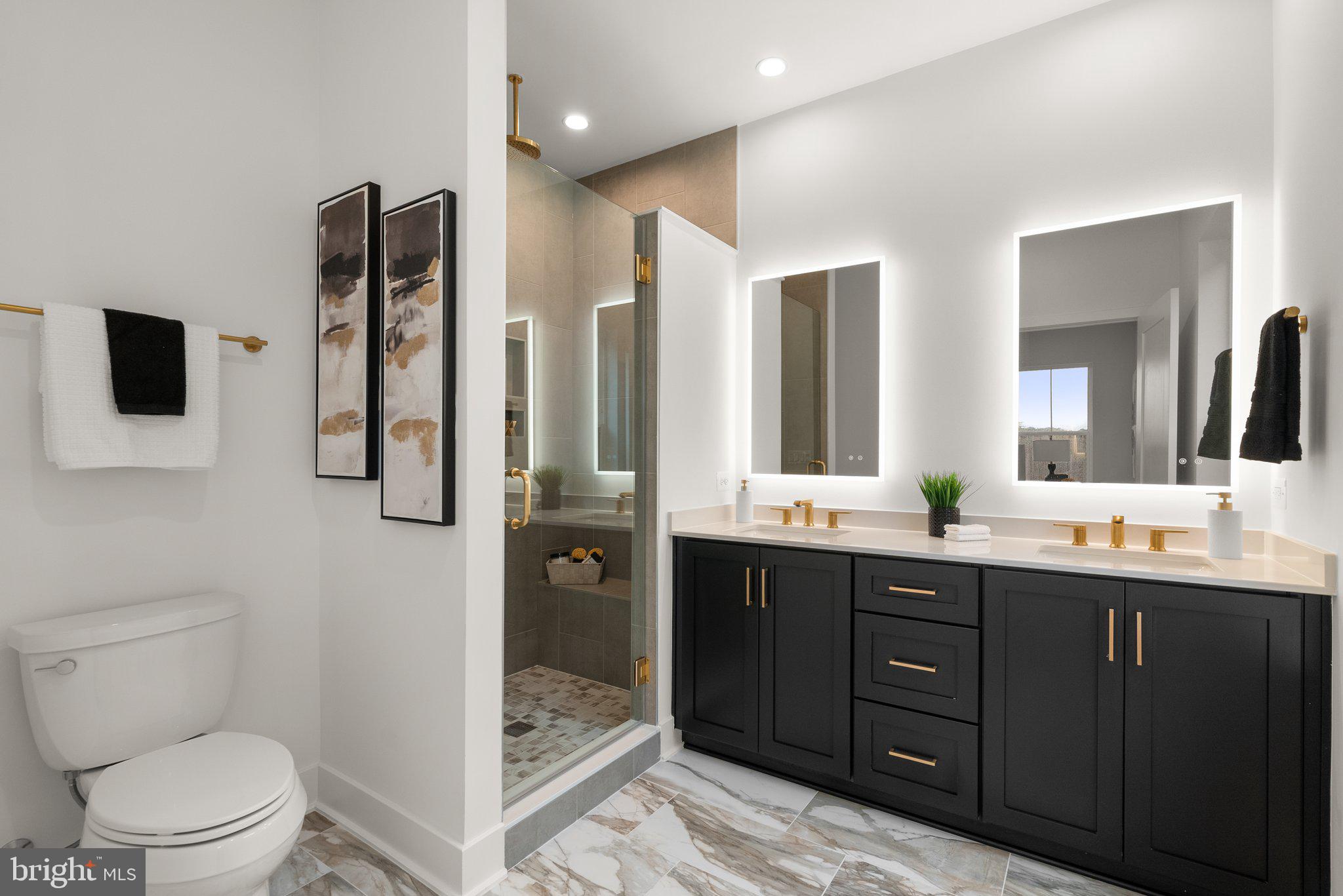 1121 Polaris Road Potomac, MD 20854 - Photo 19 of 51 a bathroom with a double vanity sink toilet mirror and bathtub