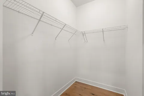 a bathroom with a double vanity sink toilet mirror and bathtub