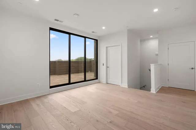 a view of an empty room with glass door