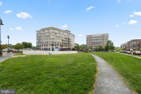 a view of a city with tall buildings and a big yard
