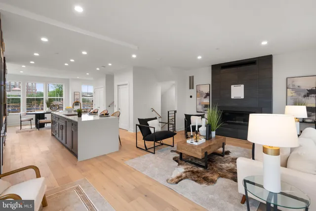 a living room with furniture and kitchen view