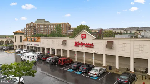 a front view of a building with cars parked
