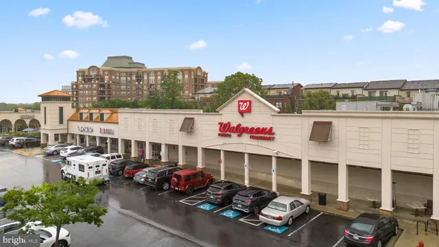 a front view of a building with cars parked