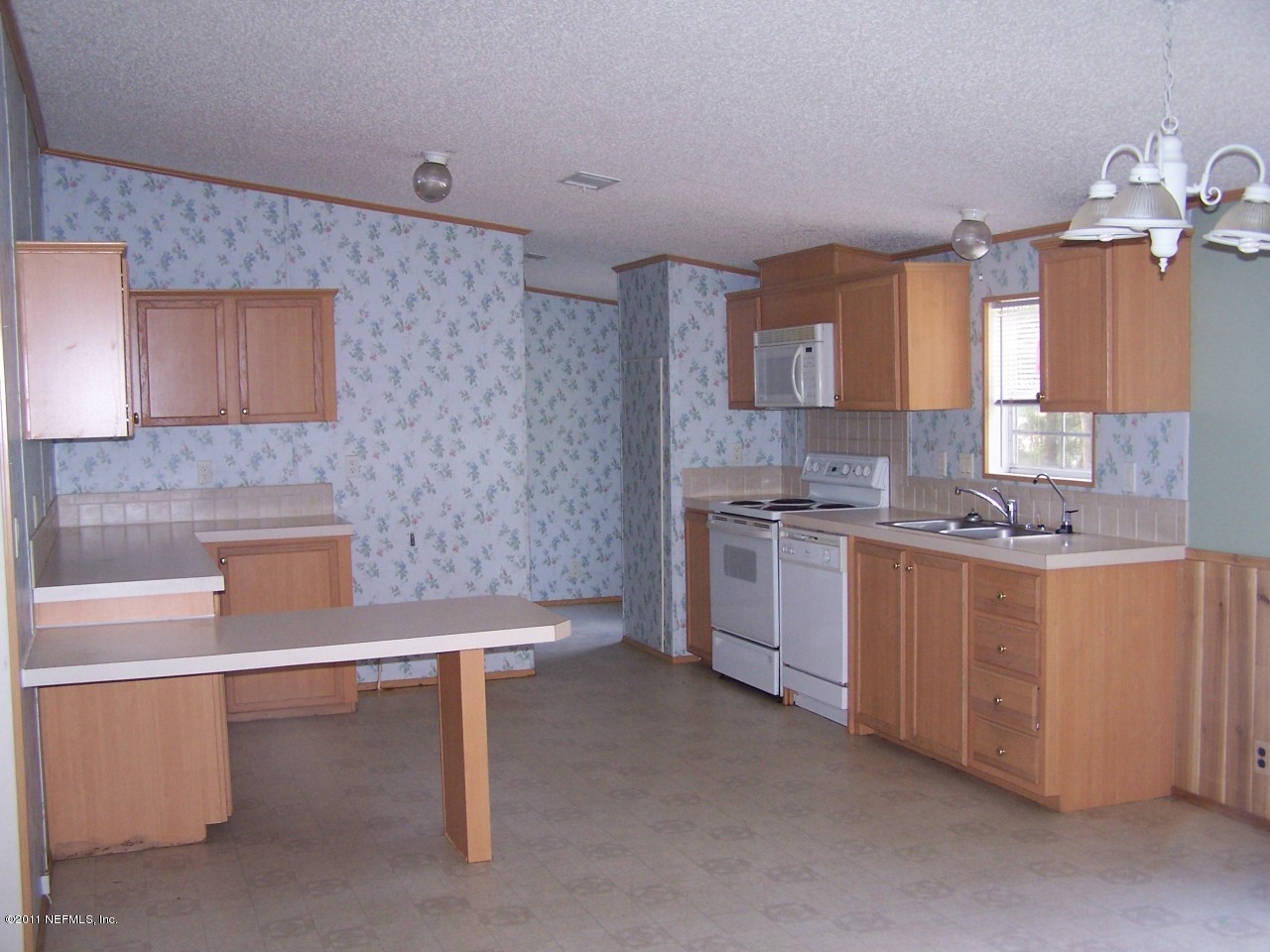 87471 Haven Road Yulee, FL 32097 - Photo 2 of 5 a kitchen with a sink cabinets and window