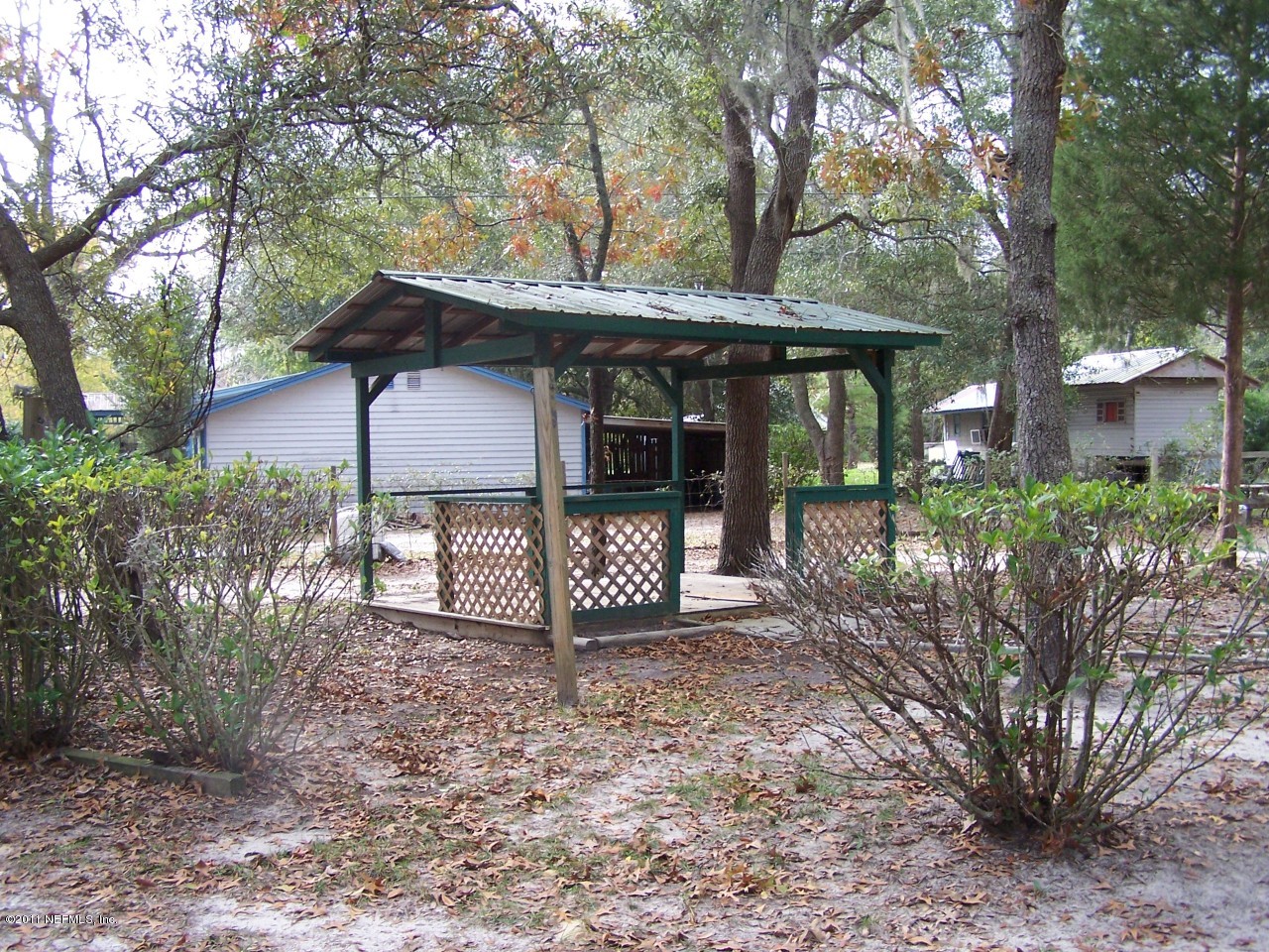 87471 Haven Road Yulee, FL 32097 - Photo 3 of 5 a view of a house with a large tree and a yard