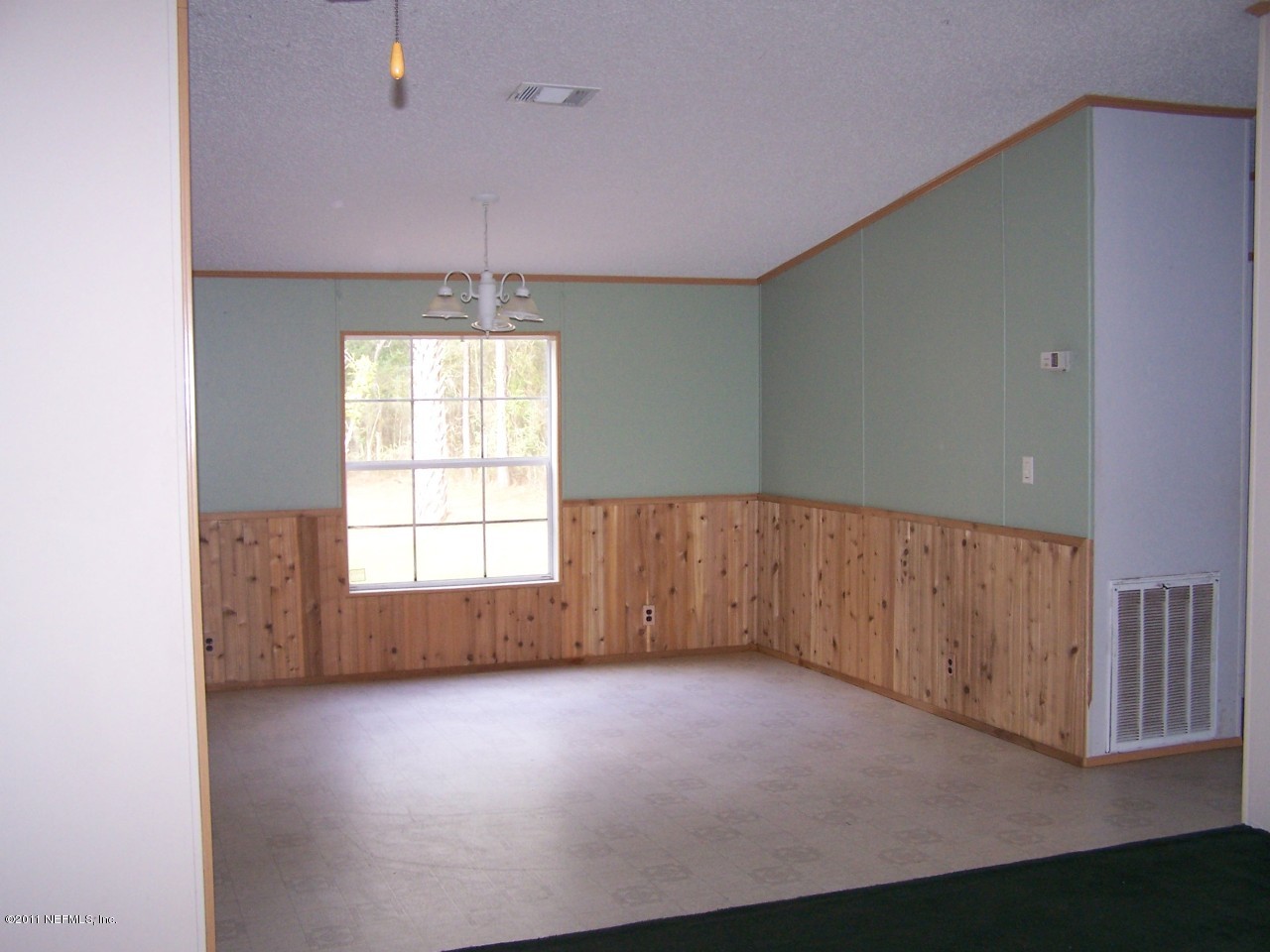 87471 Haven Road Yulee, FL 32097 - Photo 4 of 5 an empty room with a empty space and windows