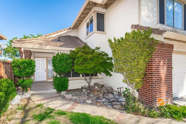 a front view of a house with garden
