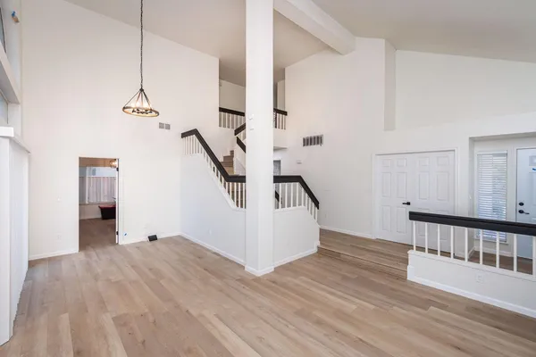 a view of a room with wooden floor and stairs