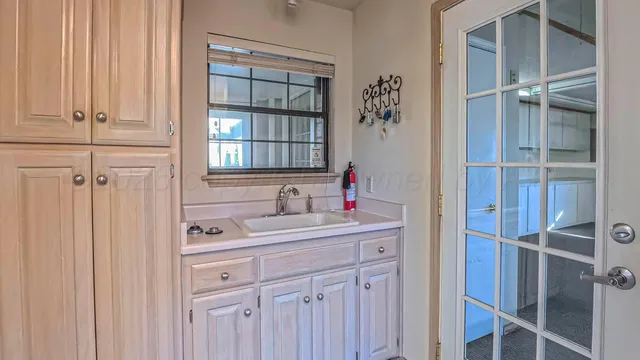 a bathroom with a sink toilet double vanity and granite