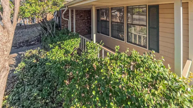 a view of an empty room with a fireplace and a window