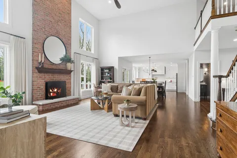 a living room with furniture large window and a fireplace