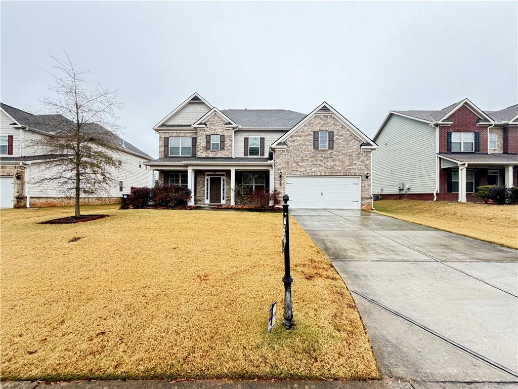 1545 Dahlia Drive Cumming, GA 30040 - Photo 1 of 50 a front view of a house with a yard