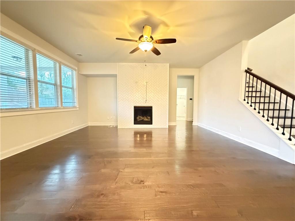 1545 Dahlia Drive Cumming, GA 30040 - Photo 12 of 50 a view of an empty room with wooden floor and a window